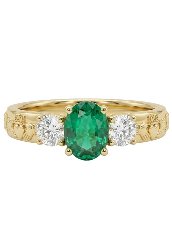 Gold ring with a green gemstone and two white stones on a white background