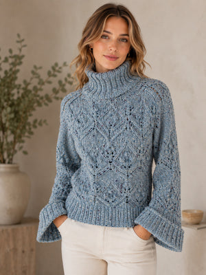 Woman wearing a blue knitted sweater in a home setting