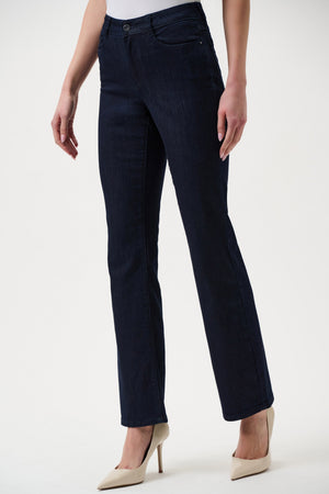 Navy blue jeans worn by a person on a white background