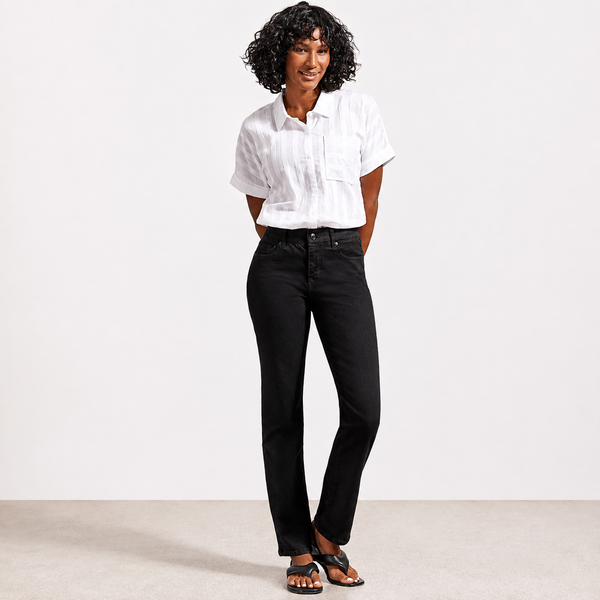 A woman modeling a white short-sleeve button-up shirt and black straight-leg jeans against a clean white studio background.