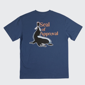 A navy blue short-sleeve t-shirt with a graphic on the front showing a seal wearing a top hat next to the text 'Seal of Approval' in orange, displayed on a light gray background.