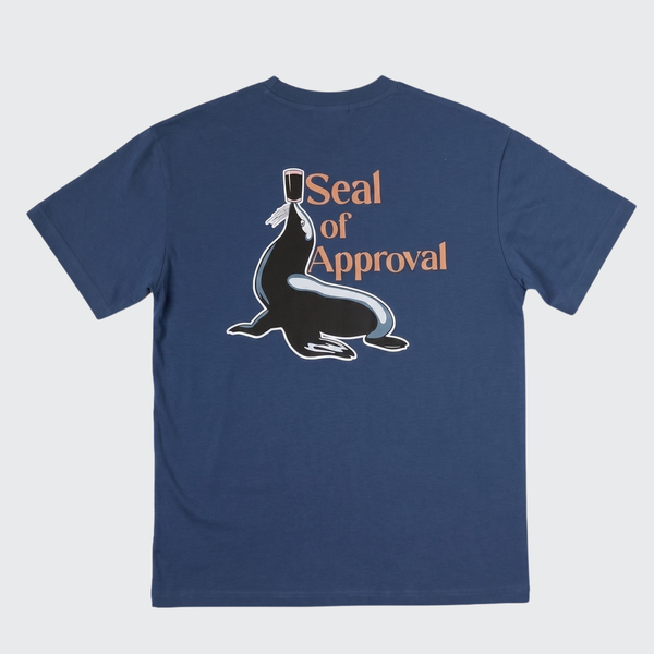 A navy blue short-sleeve t-shirt with a graphic on the front showing a seal wearing a top hat next to the text 'Seal of Approval' in orange, displayed on a light gray background.